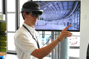 Sean Wilson, Augmented Reality Developer with the AMRC’s Integrated Manufacturing Group, moves the holographic image of a robot with the flick of a finger, using Microsoft’s new HoloLens technology.